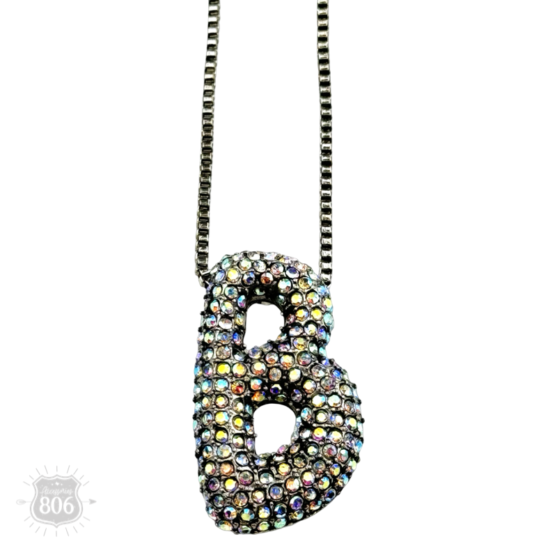 Rhinestone letter pendant on silver necklace